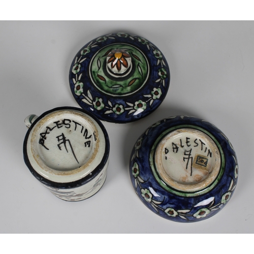 74 - Two pieces of Palestine pottery to include a circular box and cover with foliate decoration painted ... 