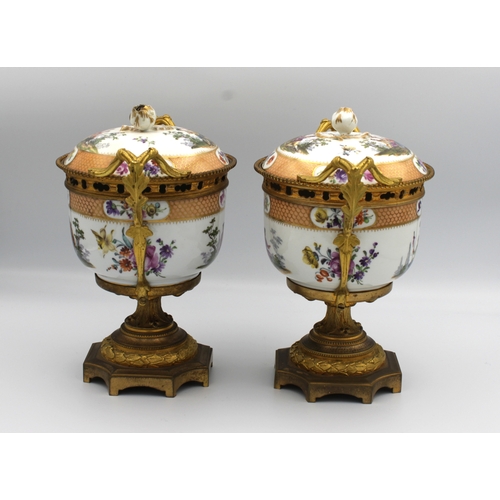 8 - A pair of Meissen ormolu mounted potpourri urns and covers 19th Century, painted with scenes of cour... 