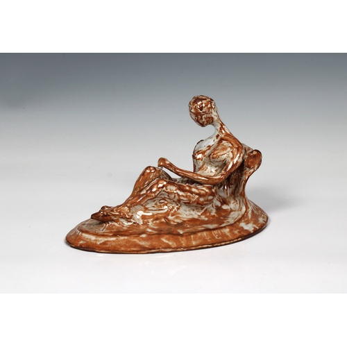 83 - Guernsey Studio pottery - Elizabeth Ann Macphail (1939-89) A reclining nude sculpture in mottled bro... 