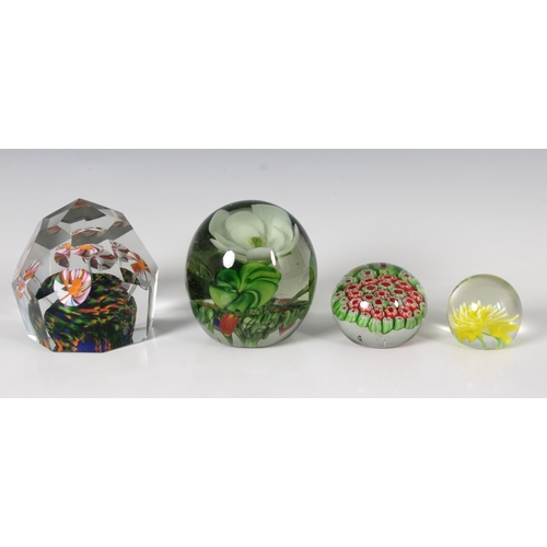 125 - Four glass paperweights unmarked, largest 8.3cm. high.