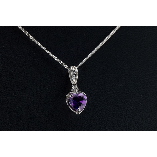 1259 - An amethyst and diamond pendant in 9ct white gold, the heart-shaped claw-set amethyst suspended belo... 