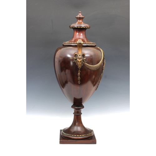 138 - A mahogany and ormolu mounted urn form wine cooler19th century, with waisted turned cover, ram's hea... 