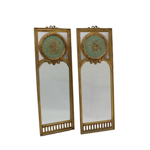 152 - A pair of 19th century Continental gilt wood mirrorseach with a painted oil tondo on panel of cherub... 