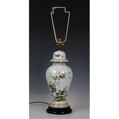 155 - A 20th century Limoges porcelain baluster vase lampdecorated with exotic birds, on a wooden base, wi... 