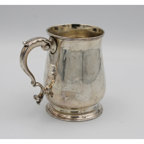 16 - A George III silver baluster tankardmaker 'I.D', London, 1772, of plain baluster form with leaf capp... 