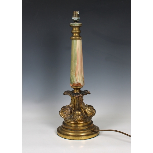 179 - An ornate 20th century ormolu and onyx table lampformed of an onyx column above an ormolu base incor... 