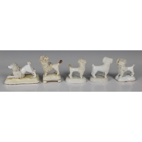 29 - Five miniature Staffordshire Poodle figurineswith flocked accents, raised on shaped bases, the large... 