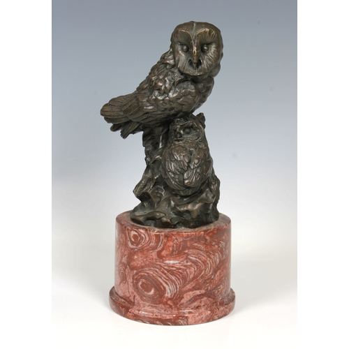 32 - Miguel Fernando L¢pez 'Milo' (b.1955) A bronze figure of two owlson rock, red ashlar marble plinth, ... 