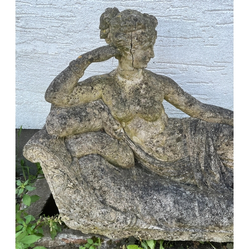 270 - Garden statuary - A reconstituted stone figure of a recumbent female on a chaise longue / day bed91c... 