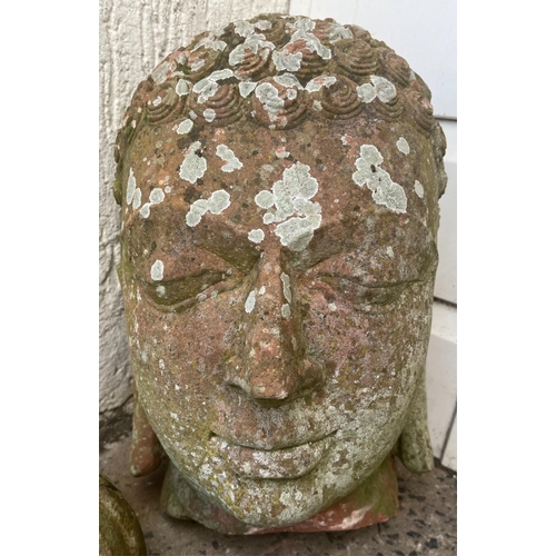 271 - Garden statuary - A weathered terracotta Buddha head42cm. high, together with a smaller head. (2)