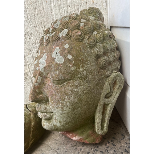 271 - Garden statuary - A weathered terracotta Buddha head42cm. high, together with a smaller head. (2)