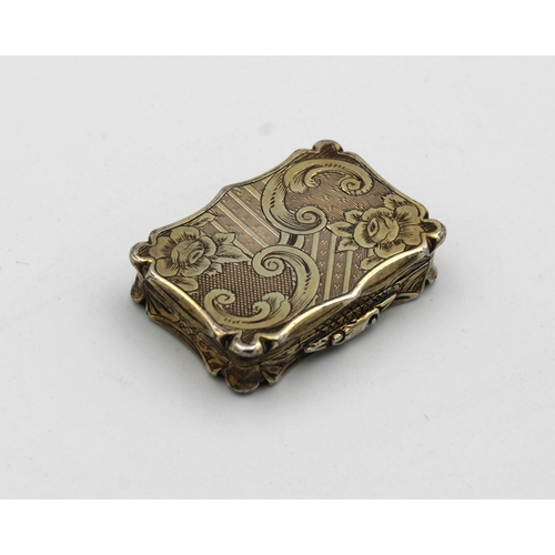 284 - A Victorian silver gilt shaped rectangular vinaigretteNathaniel Mills, Birmingham,1845, scroll & flo... 