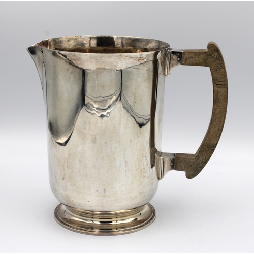 305 - A silver water jug of plain design with composite handleThomas Bradbury & Sons Ltd, Sheffield, 1960,... 