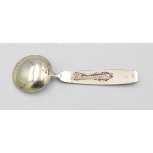 353 - A Danish sterling silver and enamel caddy spoon by Anton Michelsenthe handle with enamel figures, to... 