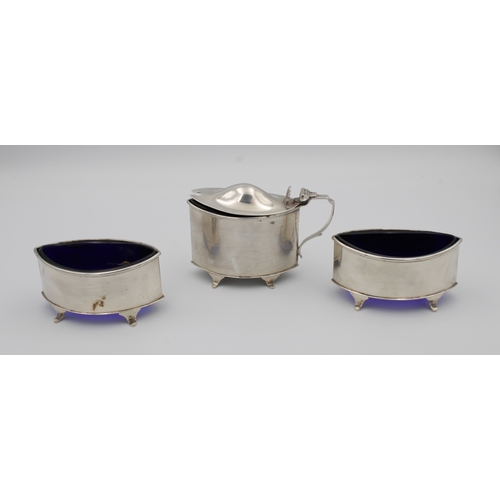 395 - An Edwardian silver three piece navette shape cruetcomprising mustard of plain form with dome hinged... 