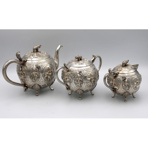 418 - An Indian silver (white metal) three piece Bachler's tea service with raised decoration of Indian de... 