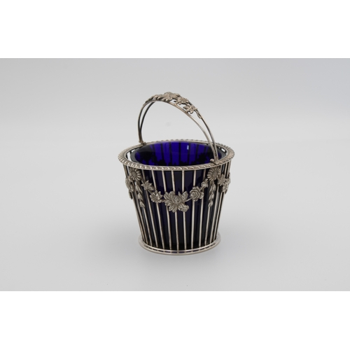 503 - A silver pierced swing handle bon bon basketC J Vander Ltd, London, 1976, of typical pail form with ... 