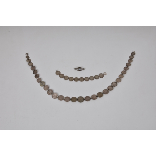 570 - A silver coin necklace and braceletthe necklace made up of twenty nine various graduated silver coin... 