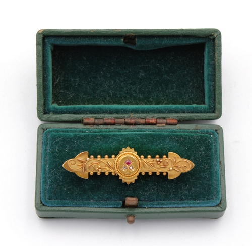 602 - A 15ct gold ruby & diamond bar brooch.