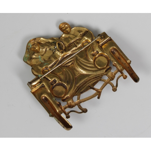 656 - A gilt metal brooch in the form of a veteran car set with polished semi precious stonesfor headlight... 