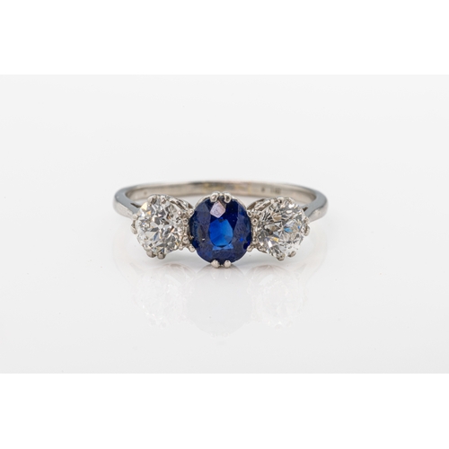 720 - An early 20th century sapphire and diamond three stone platinum ringthe central mixed cut sapphire, ... 