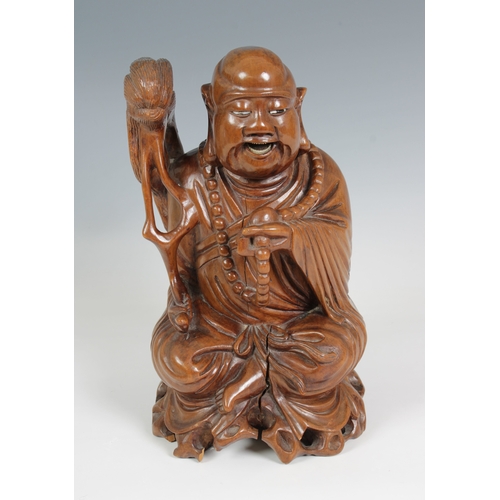 778 - Oriental carved wooden figure of a laughing Buddha (Guernsey bidders ONLY)seated, holding beads and ... 