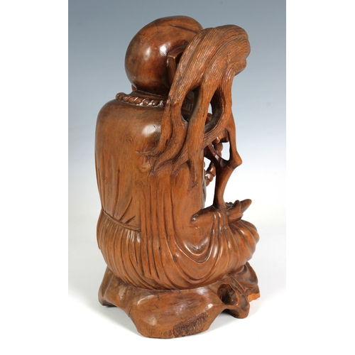 778 - Oriental carved wooden figure of a laughing Buddha (Guernsey bidders ONLY)seated, holding beads and ... 