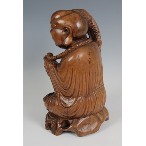 778 - Oriental carved wooden figure of a laughing Buddha (Guernsey bidders ONLY)seated, holding beads and ... 