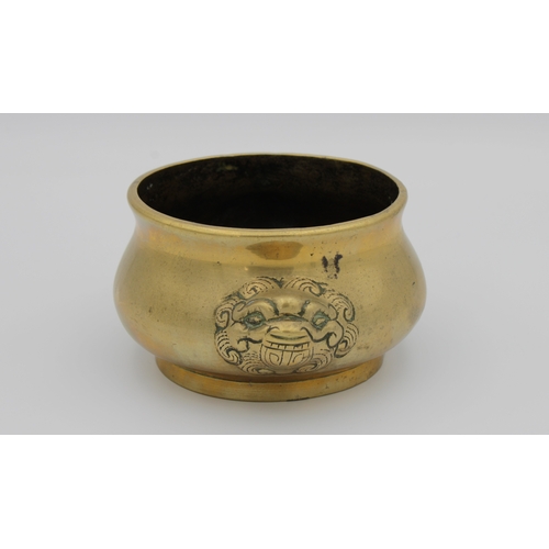 782 - A Chinese polished bronze cauldron censerof typical form with twin mask handles, character mark to b... 