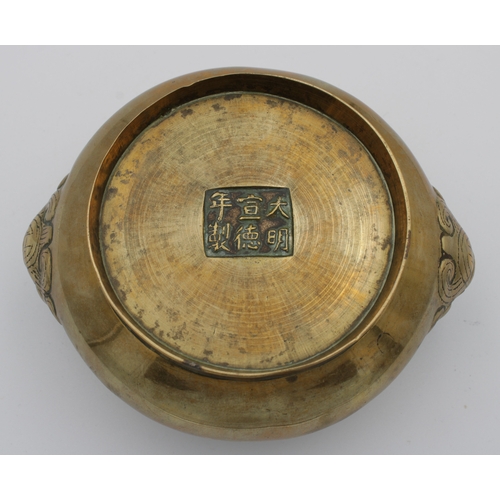 782 - A Chinese polished bronze cauldron censerof typical form with twin mask handles, character mark to b... 