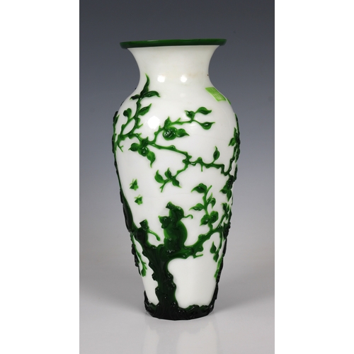 783 - A Peking Green Overlay Opaque White Glass Vase19th/20th Century, decorated with scenes of monkeys at... 