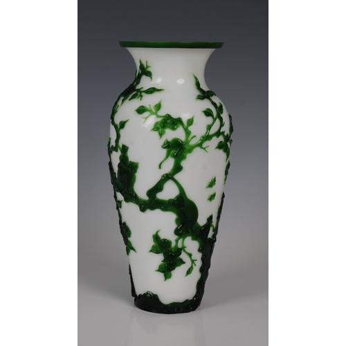 783 - A Peking Green Overlay Opaque White Glass Vase19th/20th Century, decorated with scenes of monkeys at... 