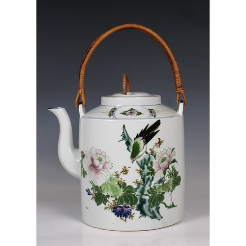 795 - A 20th century Chinese porcelain teapotof large proportions with cane handle, hand painted with a bi... 