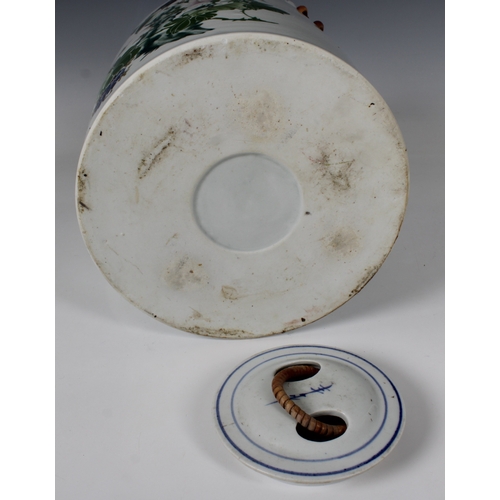 795 - A 20th century Chinese porcelain teapotof large proportions with cane handle, hand painted with a bi... 