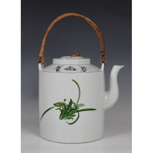 795 - A 20th century Chinese porcelain teapotof large proportions with cane handle, hand painted with a bi... 