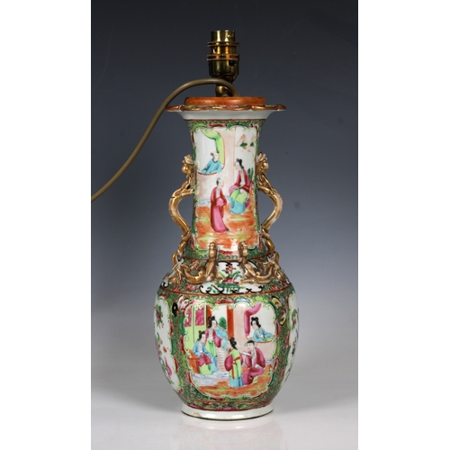 806 - A Chinese famille rose vase converted to a lamphaving applied gilt lizards and reserves of figures i... 