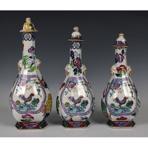 809 - Three Chinese graduated porcelain vases with coverspolychrome floral decoration each featuring a coc... 