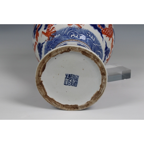 819 - A 19th century Chinese porcelain vasethe ovoid body with rouge de feu and blue decoration of dragons... 