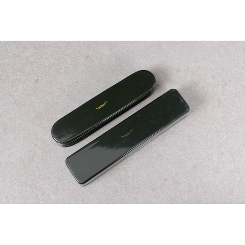 1036 - Two 20th century Russian lacquered boxesof elongated rectangular and oval form, the hinged covers de... 