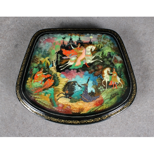 1039 - A mid to late 20th century Russian lacquered boxof satchel form, the hinged cover depicting a mythic... 