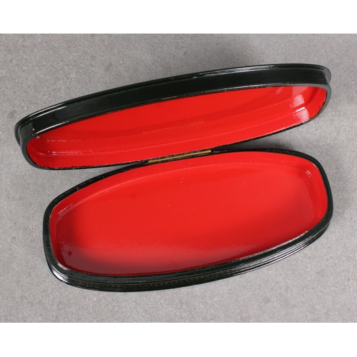 1042 - A mid to late 20th century Russian lacquered boxof elongated oval form, the hinged cover depicting a... 