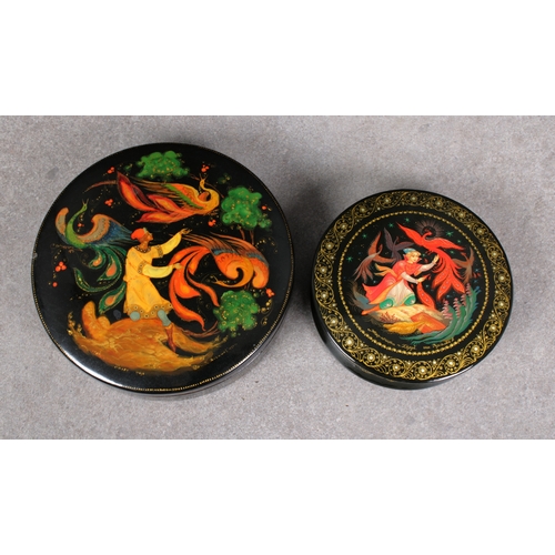 1053 - Two mid to late 20th century Russian Lacquered boxesof circular form with pull-off covers, depicting... 