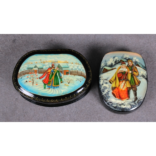 1058 - Two 20th century Russian Lacquered boxesof shaped oval forms, the hinged covers, depicting figures i... 