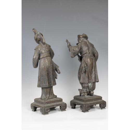 1099 - A pair of late 19th century European spelter figuresof a Chinese woman serving tea and a Chinese man... 