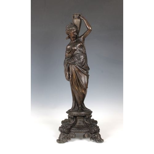 1102 - A decorative late 19th century metal candlestickformed of a classical female figure on a four legged... 