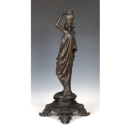 1102 - A decorative late 19th century metal candlestickformed of a classical female figure on a four legged... 