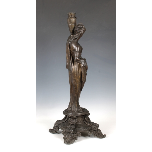 1102 - A decorative late 19th century metal candlestickformed of a classical female figure on a four legged... 