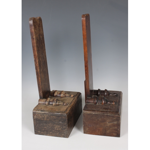 1110 - A pair of 19th century mahogany plate standsthe upright back supports set upon block plinths, having... 