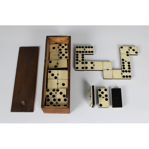 1124 - Boxed set of bone dominoes.