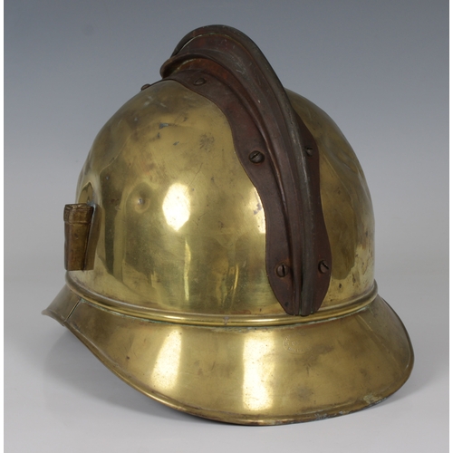 1146 - A French brass fire helmet 'SAPEURS POMPIERS DE TULLE'side plume socket, leather strap, lacks liner.